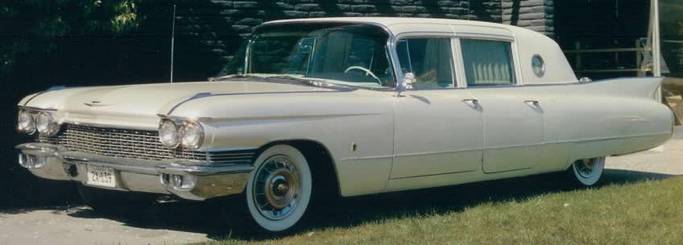 Presley's cadillac parked on the lawn in front of the house.