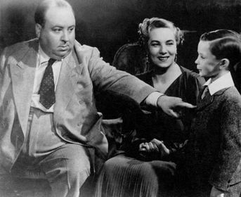 Hitchcock instructing a young boy on the set of Young and Innocent.