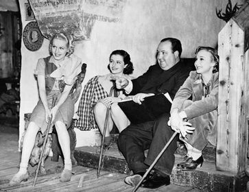 Hitchcock together with three ladies on the set of The Lady Vanishes.