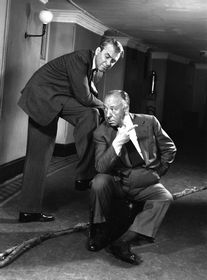 Hitch and Steward posing to the camera in a corridor.