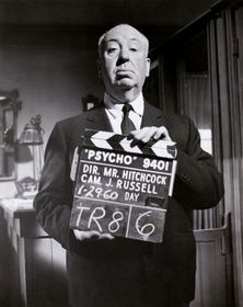 One of the most famous Hitchcock pictures in which he stands in front of camera with a table holding a Psycho clapboard.