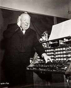 Hitch listening to a recording on the set of The Birds, screaming as if the sound would be too loud.