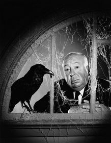 Hitch standing behind cobwebbed bars with a crow right by him.