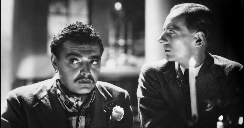 A black and white photograph of a scene featuring Peter Lorre and John Gielgud.